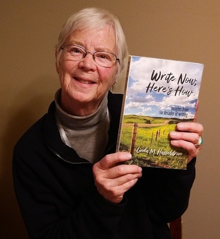 Image of Linda Hasselstrom smiling and holding up her newest book Write Now, Here's How.